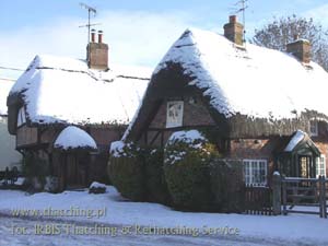 Straw roofs on the buildings of the English province, in winter